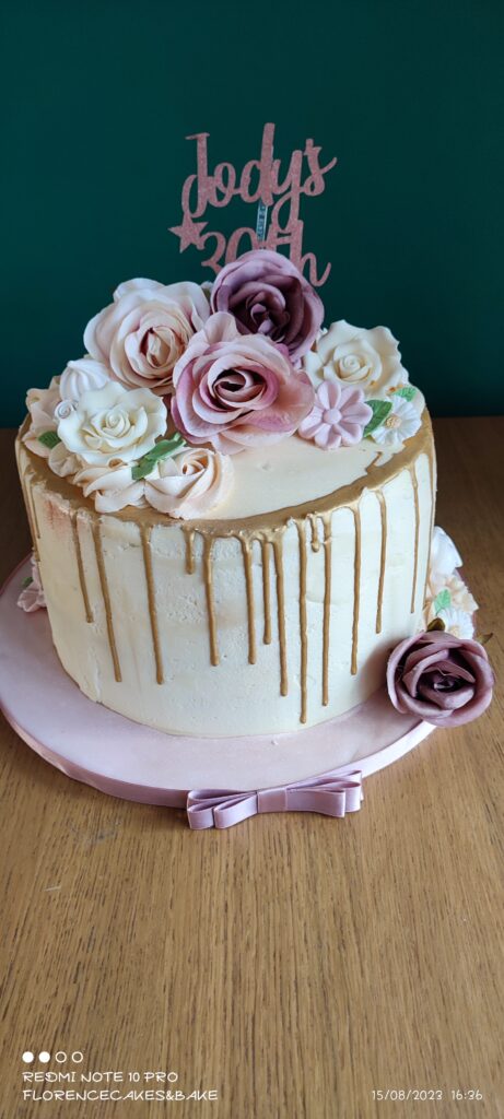 Birthday cake with roses and a drip along the top