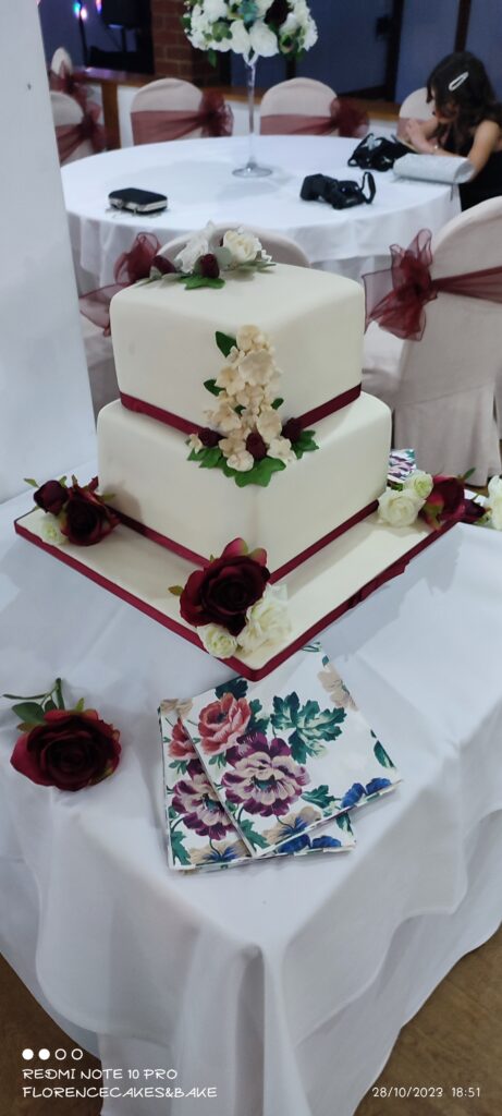 Two Tier Square cakes with burgundy ribbon and roses